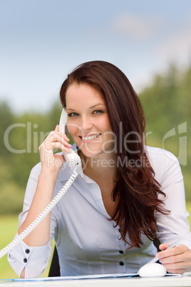 Businesswoman in nature attractive smile calling