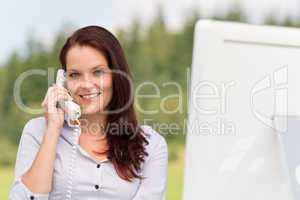 Businesswoman in nature attractive smile calling