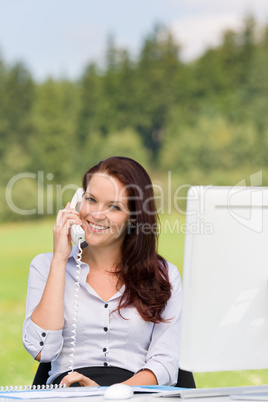 Businesswoman in nature attractive smile calling