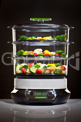 Healthy cooking, steam cooker with vegetables