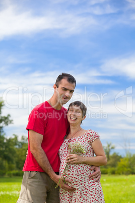 Husband hugs his pregnant wife Husband hugs his pregnant wife