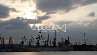 Silhouette of several cranes in a harbor, shot during sunset. Odessa, Ukraine