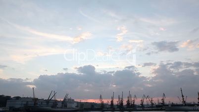 Silhouette of several cranes in a harbor, shot during sunset. Odessa, Ukraine