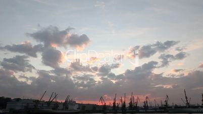 Silhouette of several cranes in a harbor, shot during sunset. Odessa, Ukraine