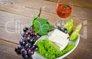 cheese and bunches of grapes