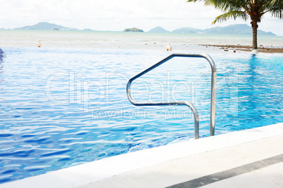 swimming pool with stair at hotel close up