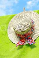 Summer straw gardener's hat on green