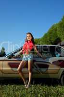 Sexy young woman stay near retro graffiti car