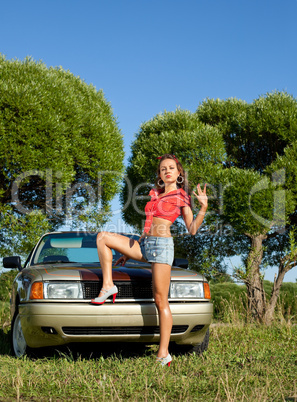 pin-up style young woman stay before retro car