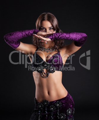 Attractive brunette girl posing in arabic dance