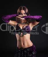 Attractive brunette girl posing in arabic dance