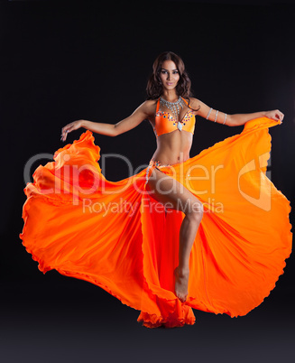 beauty dancer posing in orange veil - arabia style