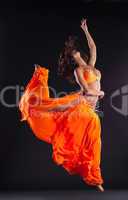 beauty dancer jump in orange veil - arabian style