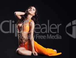 beauty naked dancer posing in orange veil