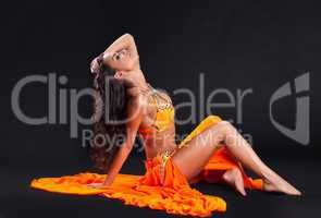 beauty naked dancer posing in orange veil