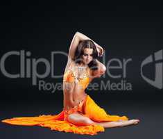 beauty naked dancer posing in orange veil