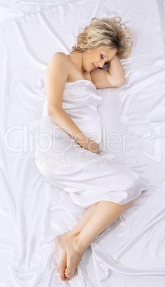 Yong beauty pregnant woman lay on white bed