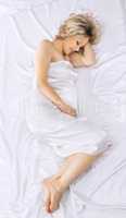 Yong beauty pregnant woman lay on white bed