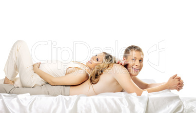Happy pregnant wife lay on smile husband in bed