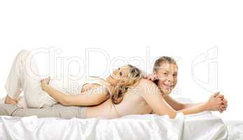 Happy pregnant wife lay on smile husband in bed