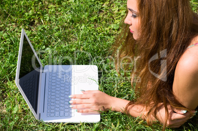 Beautiful girl with a laptop outdoor