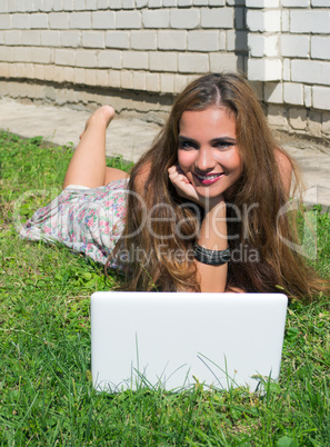 Beautiful girl with a laptop outdoor