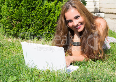 Beautiful girl with a laptop outdoor