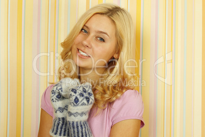 Beautiful young woman in mild winter mittens