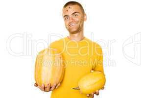 Young man holding a yellow squash