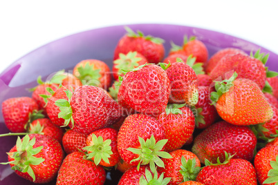 strawberries in a glass plate isolated on white