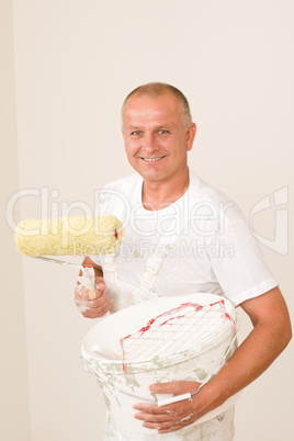 Home decorating mature man with paint roller