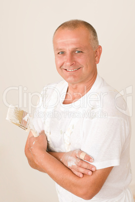 Home decorating mature man with paint brush