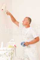 Home decorating mature man with paint roller