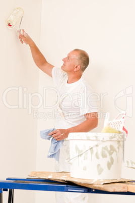 Home decorating mature man with paint roller