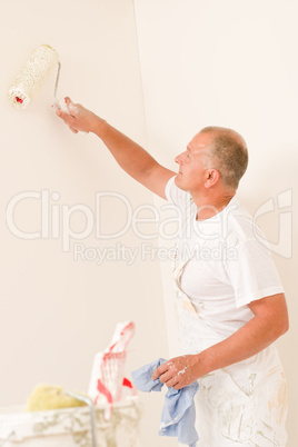 Home decorating mature man with paint roller