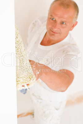 Home decorating mature man painting wall roller
