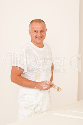 Home decorating mature man painting door brush