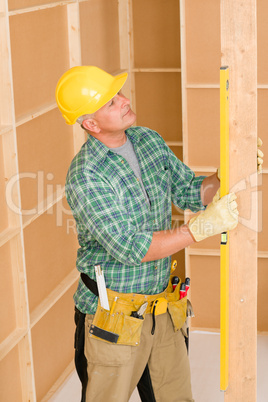 Handyman mature professional with spirit level