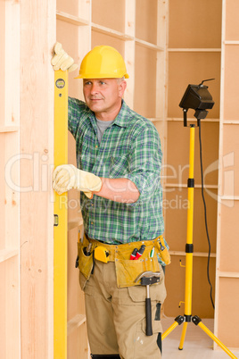 Handyman mature professional with spirit level