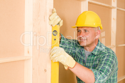 Handyman mature professional with spirit level