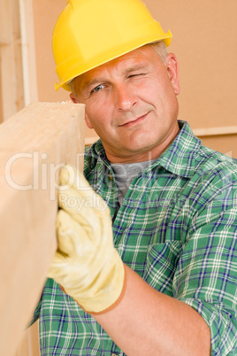 Handyman mature carpenter measure wooden beam