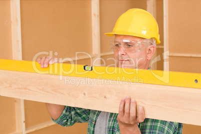 Handyman mature professional with spirit level