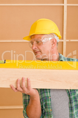 Handyman mature professional with spirit level