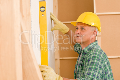 Handyman mature professional with spirit level