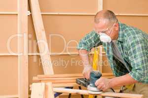 Handyman sanding wooden board diy home renovation