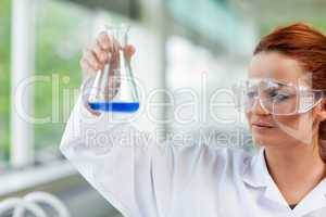 Science student looking at an Erlenmeyr flask