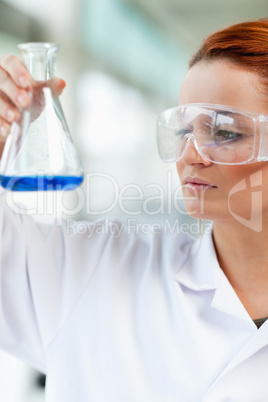 Portait of a science student looking at an Erlenmeyr flask