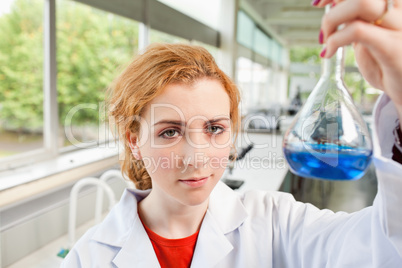 Cute science student holding a flask
