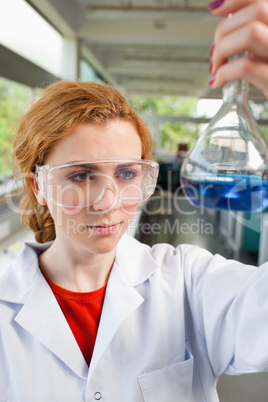 Portrait of a science student looking at a flask