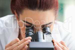 Close up of a scientist looking into a microscope